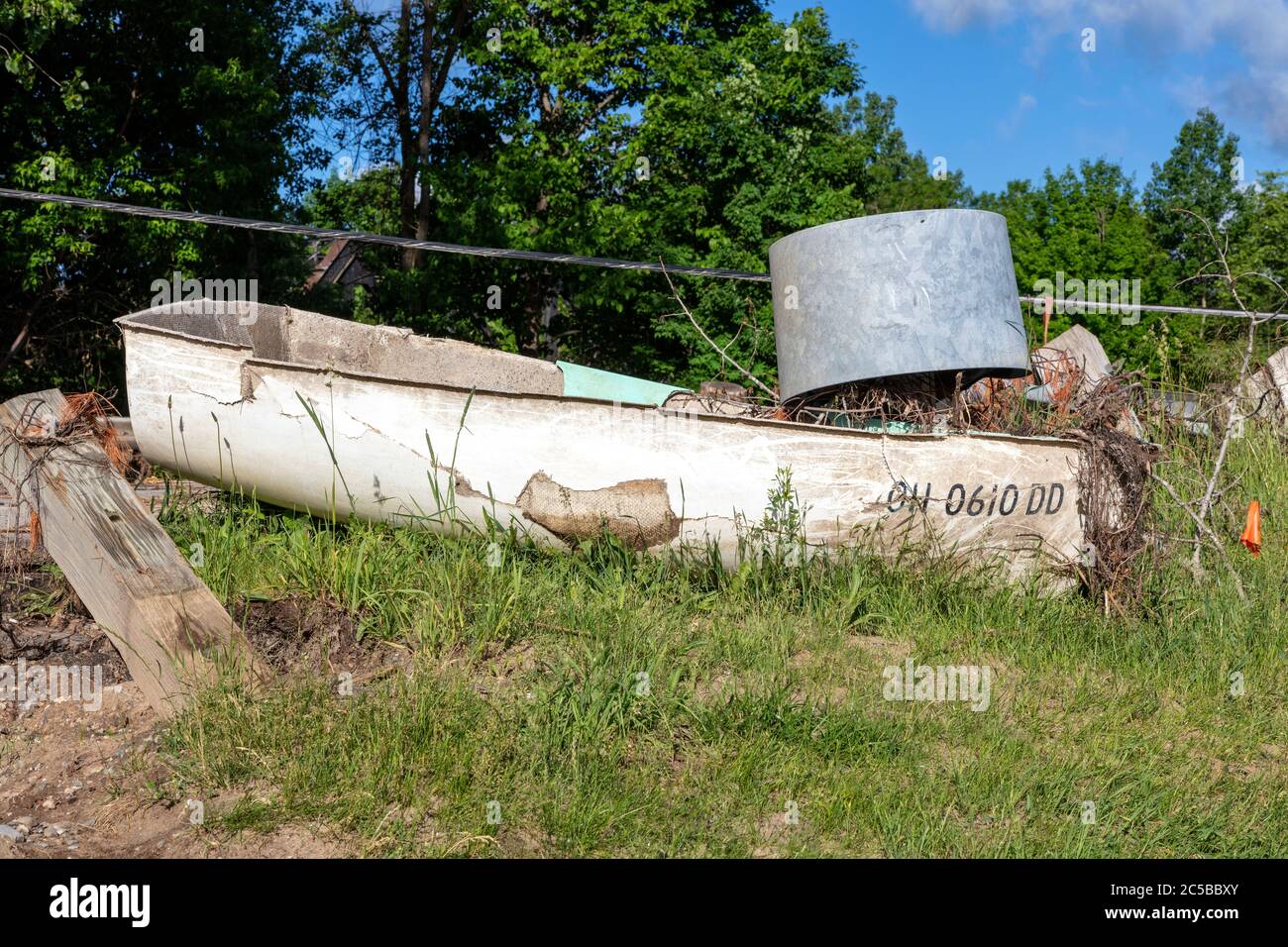 Row boat washed up, flood damage, Sanford, MI, USA. 6-11-2020, Dam broke & flooding occurred 5-20-2020, by James D Coppinger/Dembinsky Photo Assoc Stock Photo