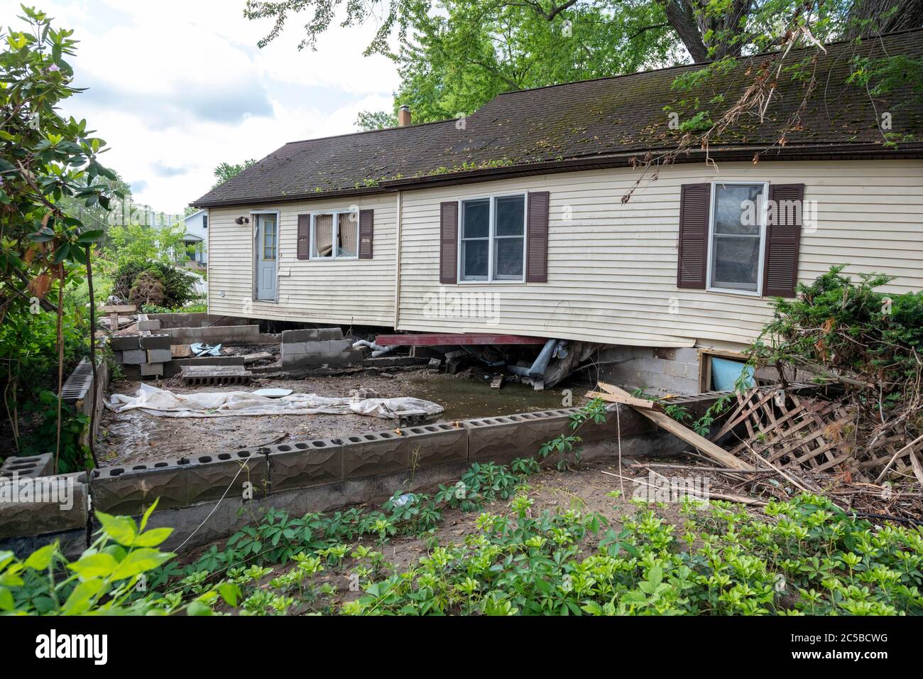 House off foundation from flooding, Sanford, MI USA. 6-11-2020, Dam breeched, & flooding 5-20-2020, by James D Coppinger/Dembinsky Photo Assoc Stock Photo