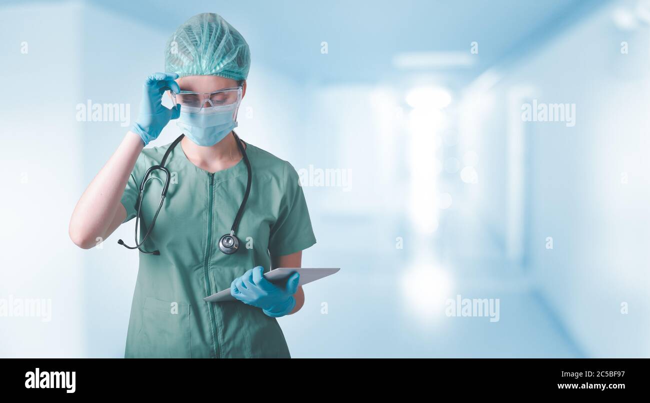 Medical Surgical Doctor and Health Care, Portrait of Surgeon Doctor in PPE Equipment in Examination Room. Medicine Female Doctors Wearing Face Mask an Stock Photo