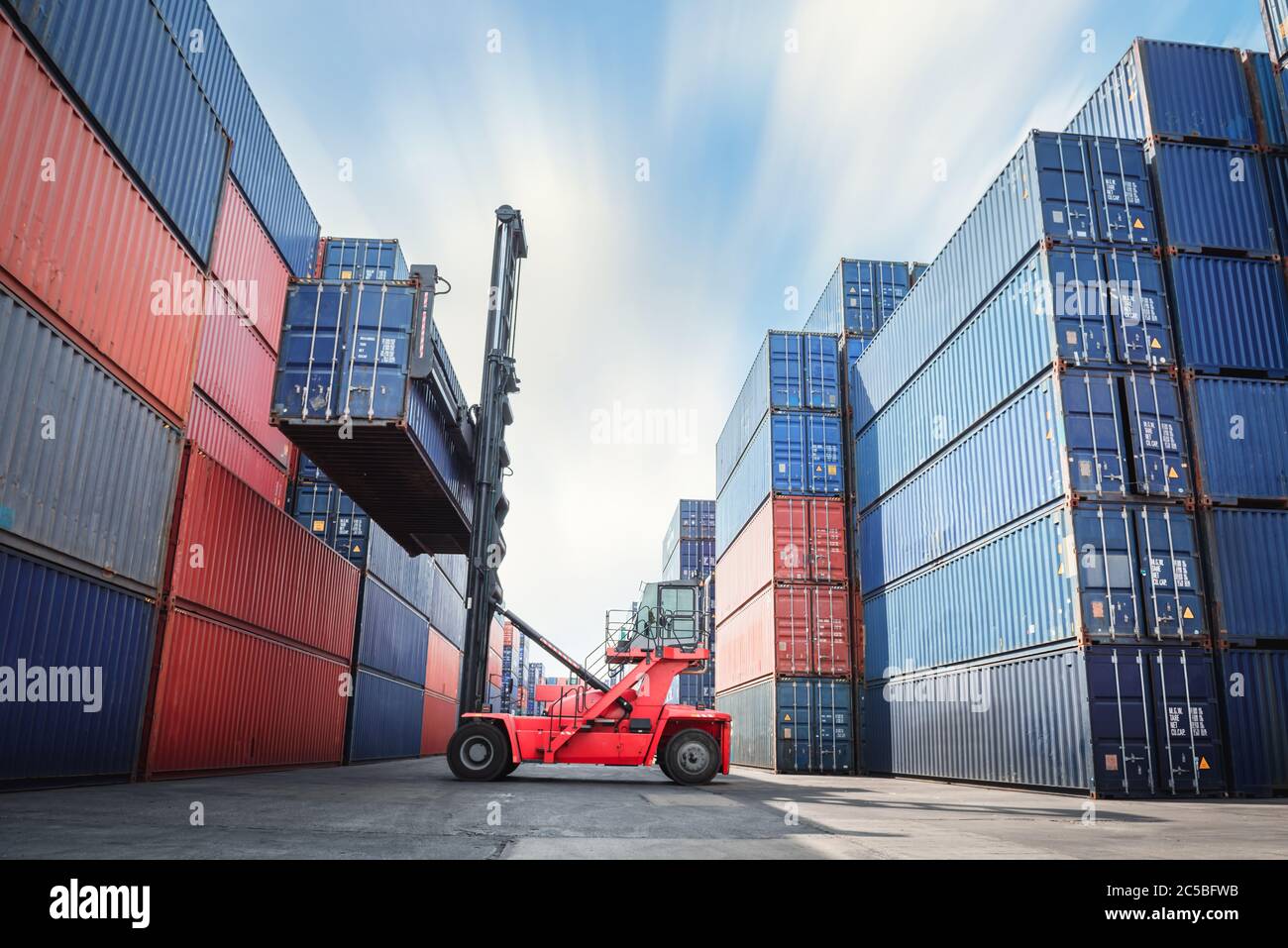 Container Ship Loading of Import/Export Freight Transportation Industry, Transport Crane Forklift is Lifting Box Containers at Port Cargo Shipping Doc Stock Photo