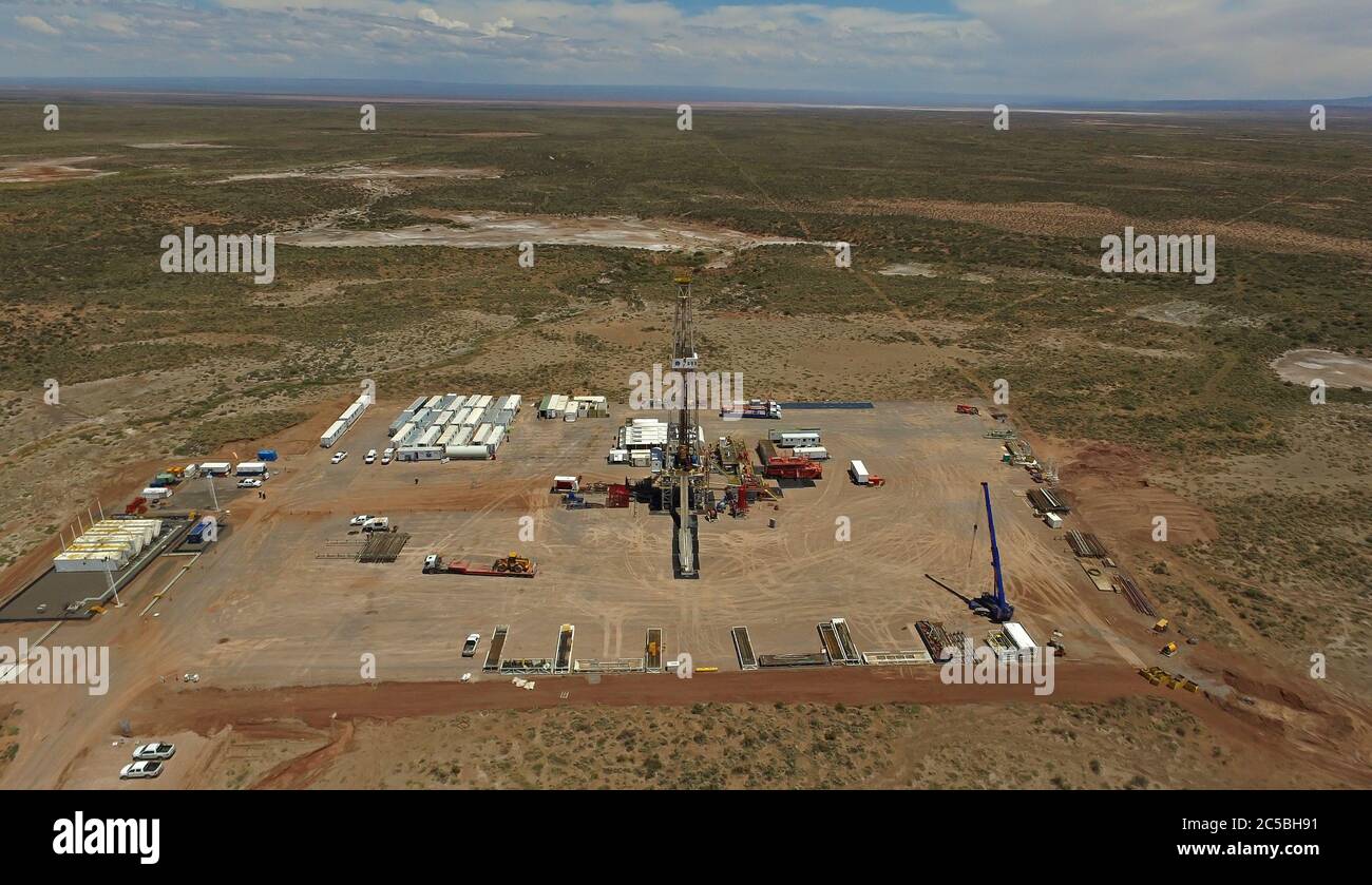 NEUQUEN, ARGENTINA - Dec 20, 2015: Extraction of unconventional oil. Battery of pumping trucks for hydraulic fracturing (Fracking). Stock Photo