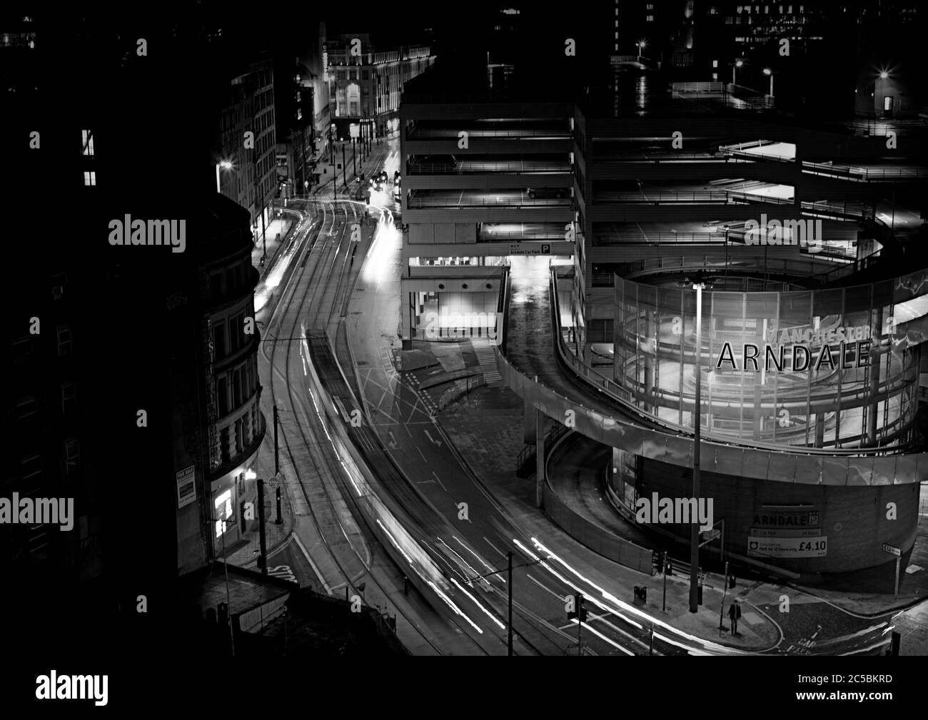 Night time street photography. Streets at night. Architecture, street lights, Arndale Centre, Manchester, car trails, time lapse, tram tracks Stock Photo