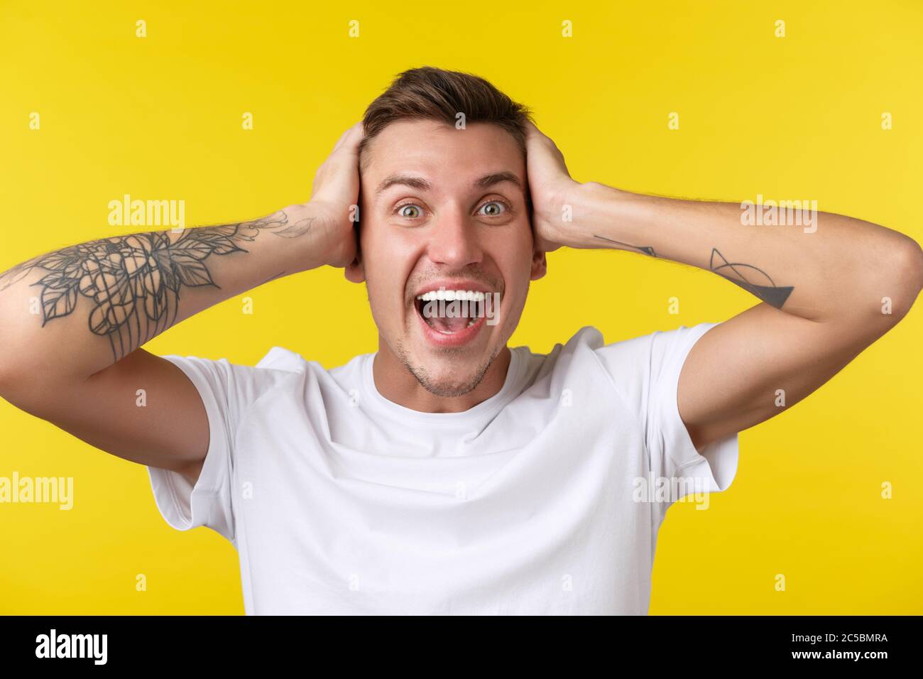 Lifestyle, summer and people emotions concept. Close-up portrait of extremely happy rejoicing young man looking surprised, cant believe he won prize Stock Photo