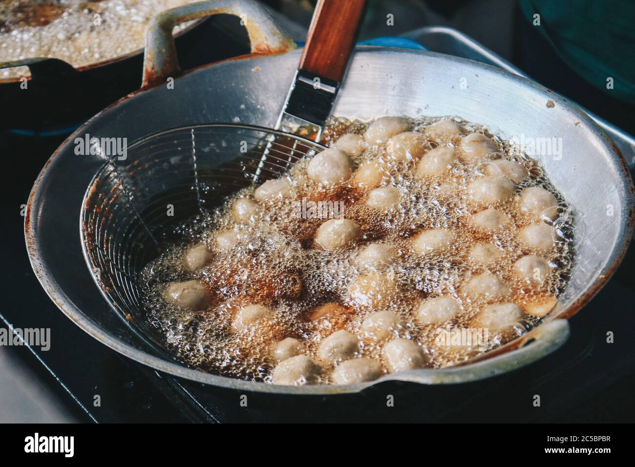 Cooking meatballs in the boiling oil in frying pan Stock Photo Alamy