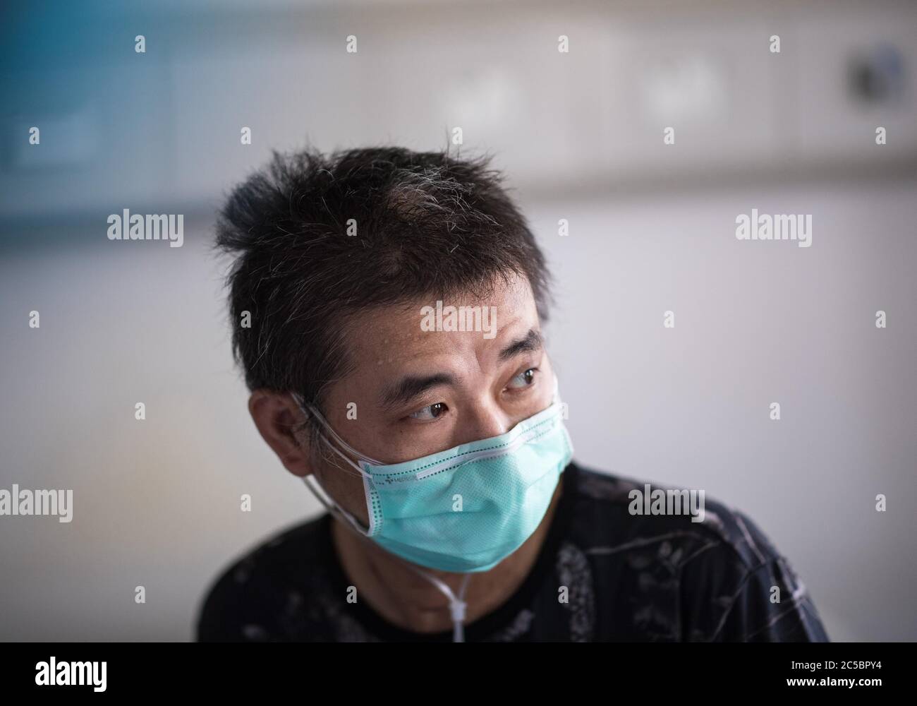(200702) -- BEIJING, July 2, 2020 (Xinhua) -- Hu Dingjiang waits for discharge in a ward of Wuhan Pulmonary Hospital in Wuhan, central China's Hubei Province, June 17, 2020. Hu, a 40-year-old recovered COVID-19 patient, was discharged from the hospital on Wednesday. He was diagnosed with the disease in early February, and was hospitalized in the ICU ward as one of the 81 severe cases in the hospital. The functions of his lungs recovered on April 5 with 40 days of extracorporeal membrane oxygenation (ECMO) support. Then he received rehabilitation training in the hospital. (Xinhua/Xiao Yijiu) Stock Photo