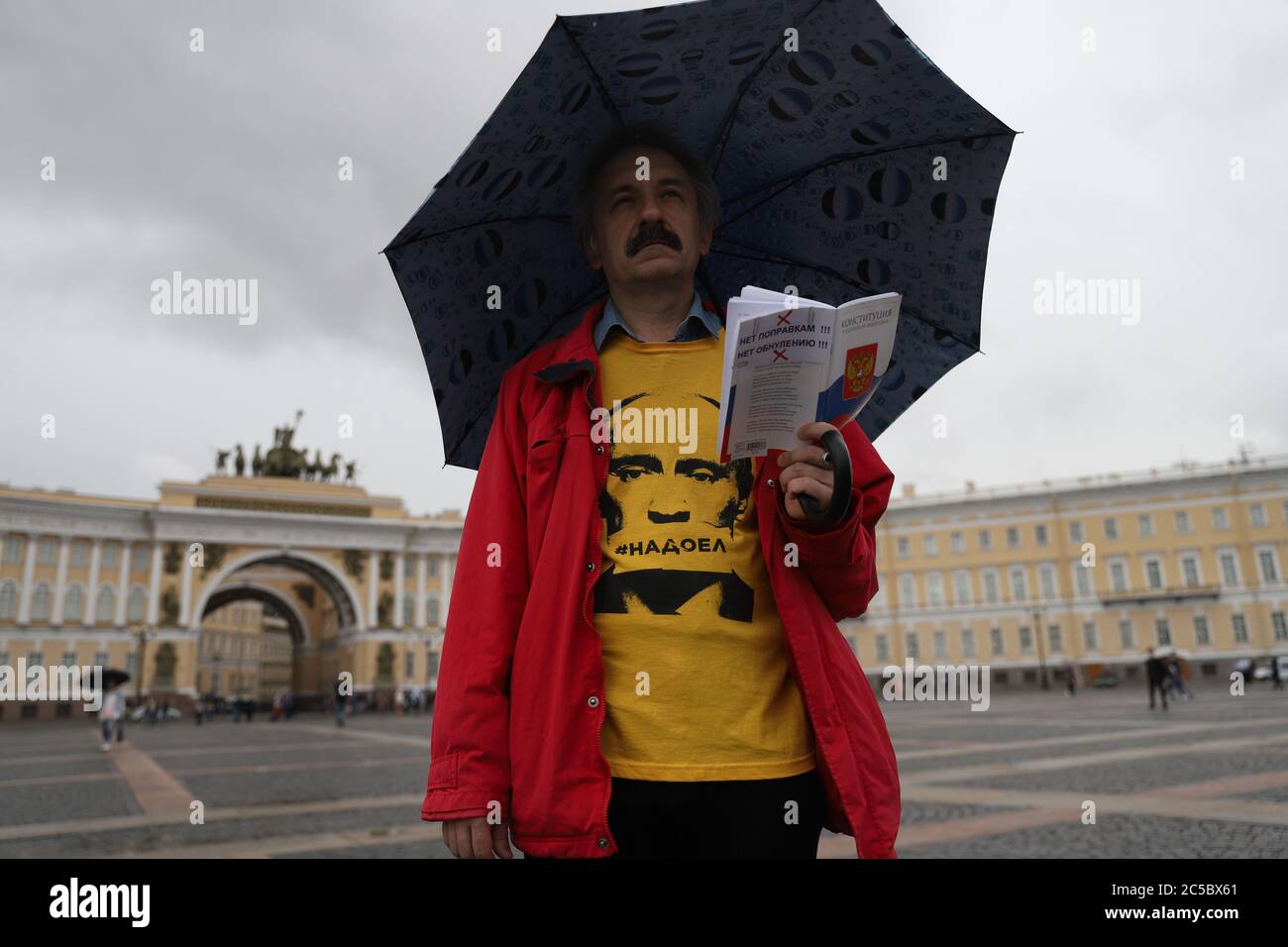 Saint Petersburg, Russia. 01st July, 2020. A man wearing a T-shirt depicting Russian President, Vladimir Putin saying 'We are tired of him' while holding a Russian Constitution during a protest against constitutional amendments.1 July is the main day of voting on the constitutional amendments that would give Russian President, Vladimir Putin the right to run for 2024 presidential elections. Credit: SOPA Images Limited/Alamy Live News Stock Photo