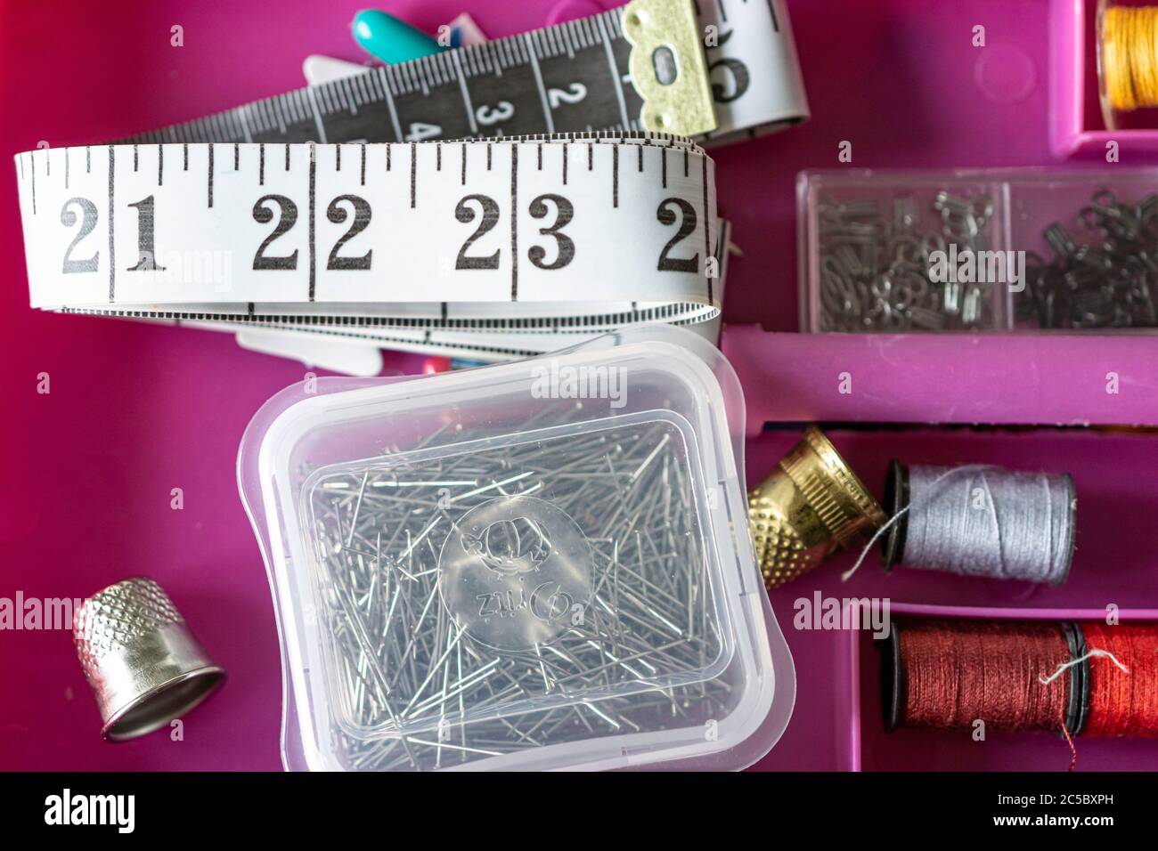 Measuring tape with collection of sewing items used by a seamstress Stock Photo Alamy