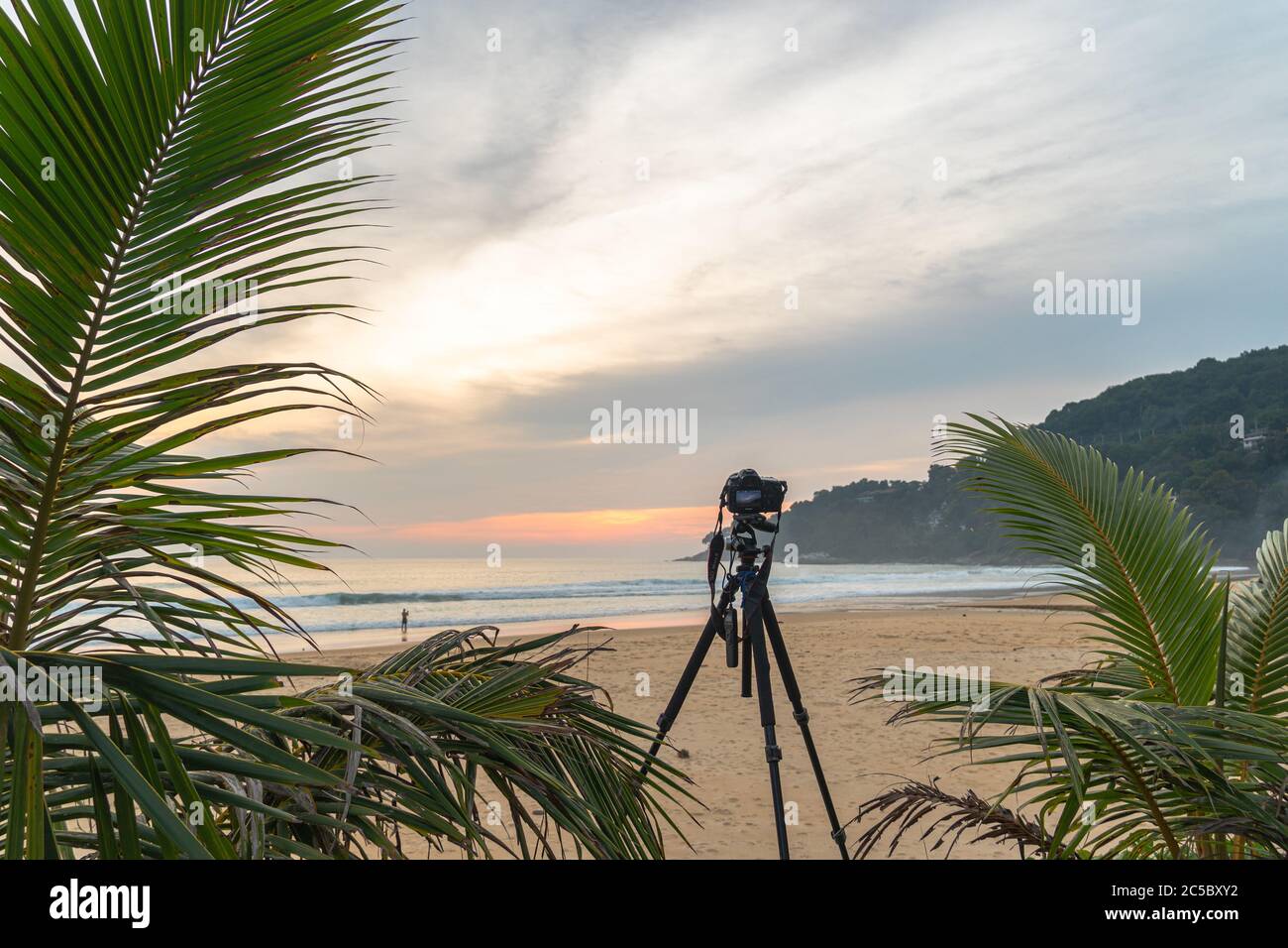the camera stand on the beach to take a photo of sunset Stock Photo - Alamy