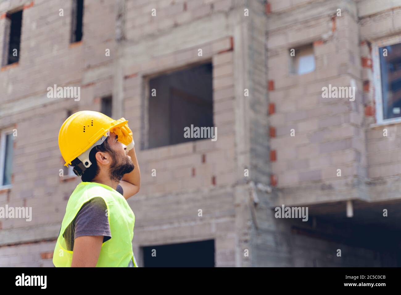 Young engineer in worker helmet on blur background Stock Photo