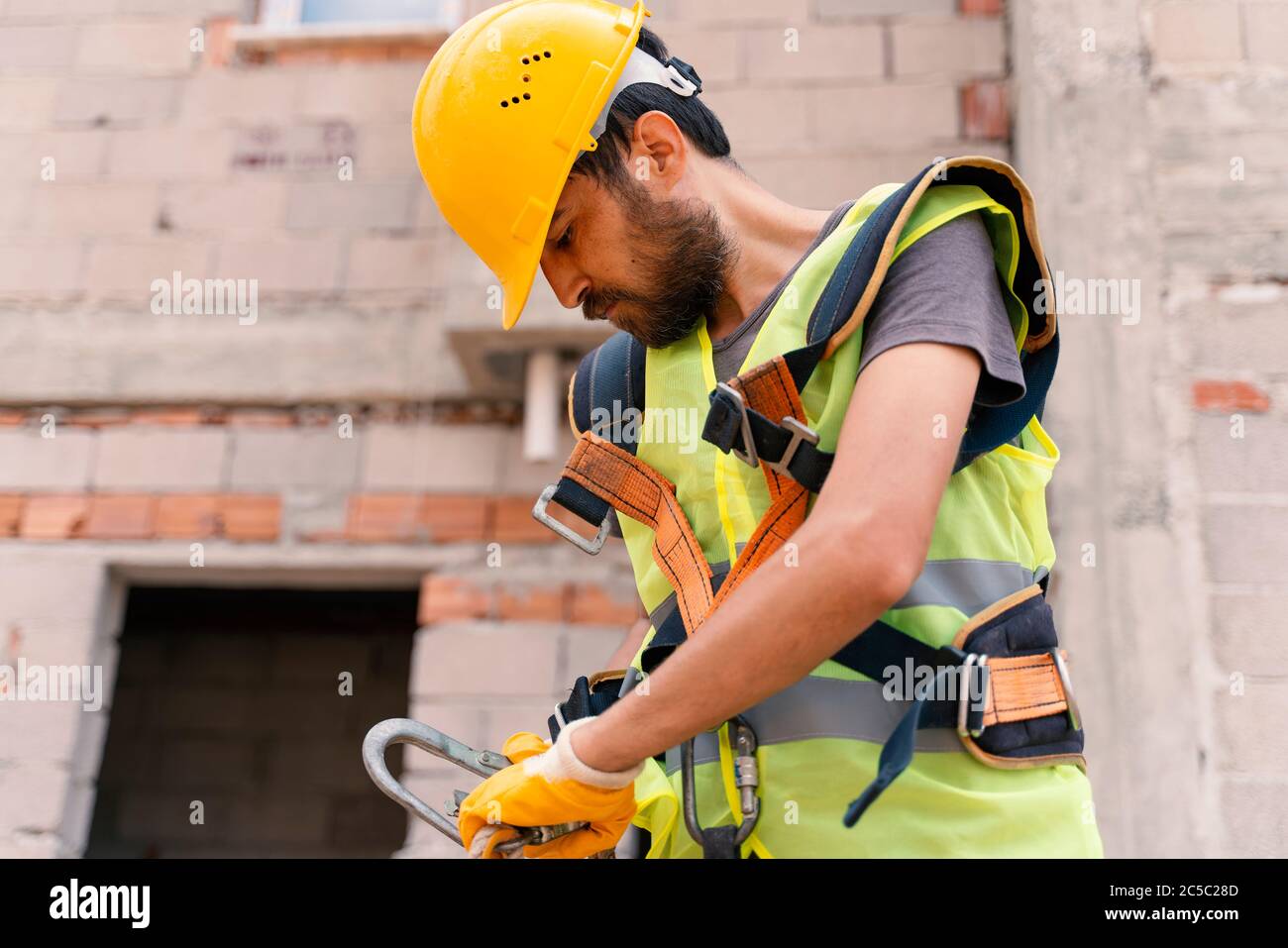 [safety body construction] Working at height equipment. Fall arrestor device for worker with hooks for safety body harness on selective focus. Constru Stock Photo
