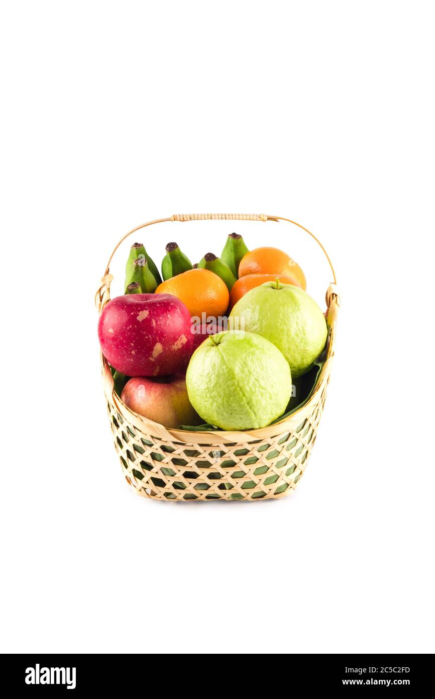 madarin orange, guava fruit, banana and red apple in gift basket on white background fruit health food isolated Stock Photo