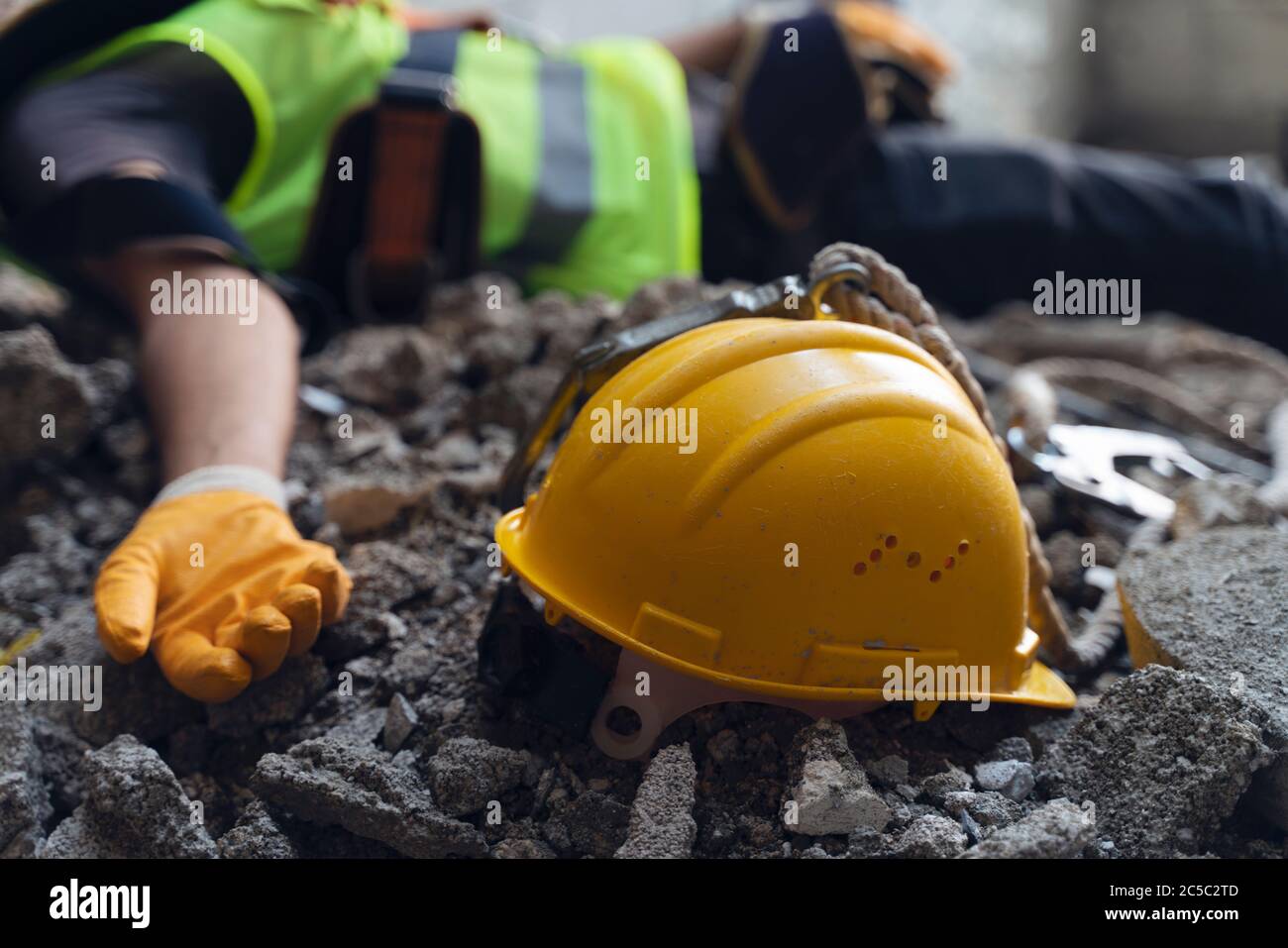 Construction worker has an accident while working on new house. Construction worker lies on the floor at the work site. Work accident Stock Photo