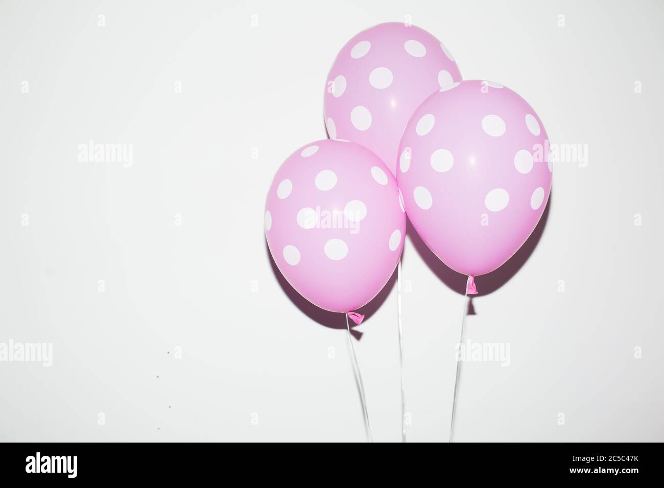 Close up pink balloons over white background isolated Stock Photo