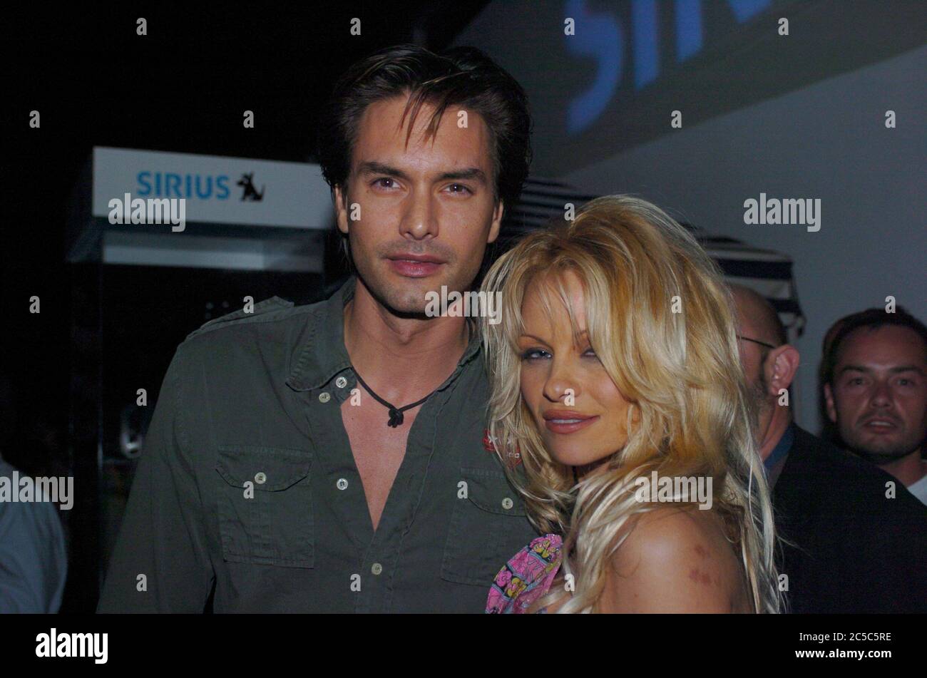 United States Of America. 19th Feb, 2004. MIAMI BEACH, FL - FEBRUARY 19: Pamela Anderson and male super model Marcus Schenkenberg on February 19, 2004 in Miami, Florida People: Pamela Anderson, Marcus Schenkenberg Credit: Storms Media Group/Alamy Live News Stock Photo