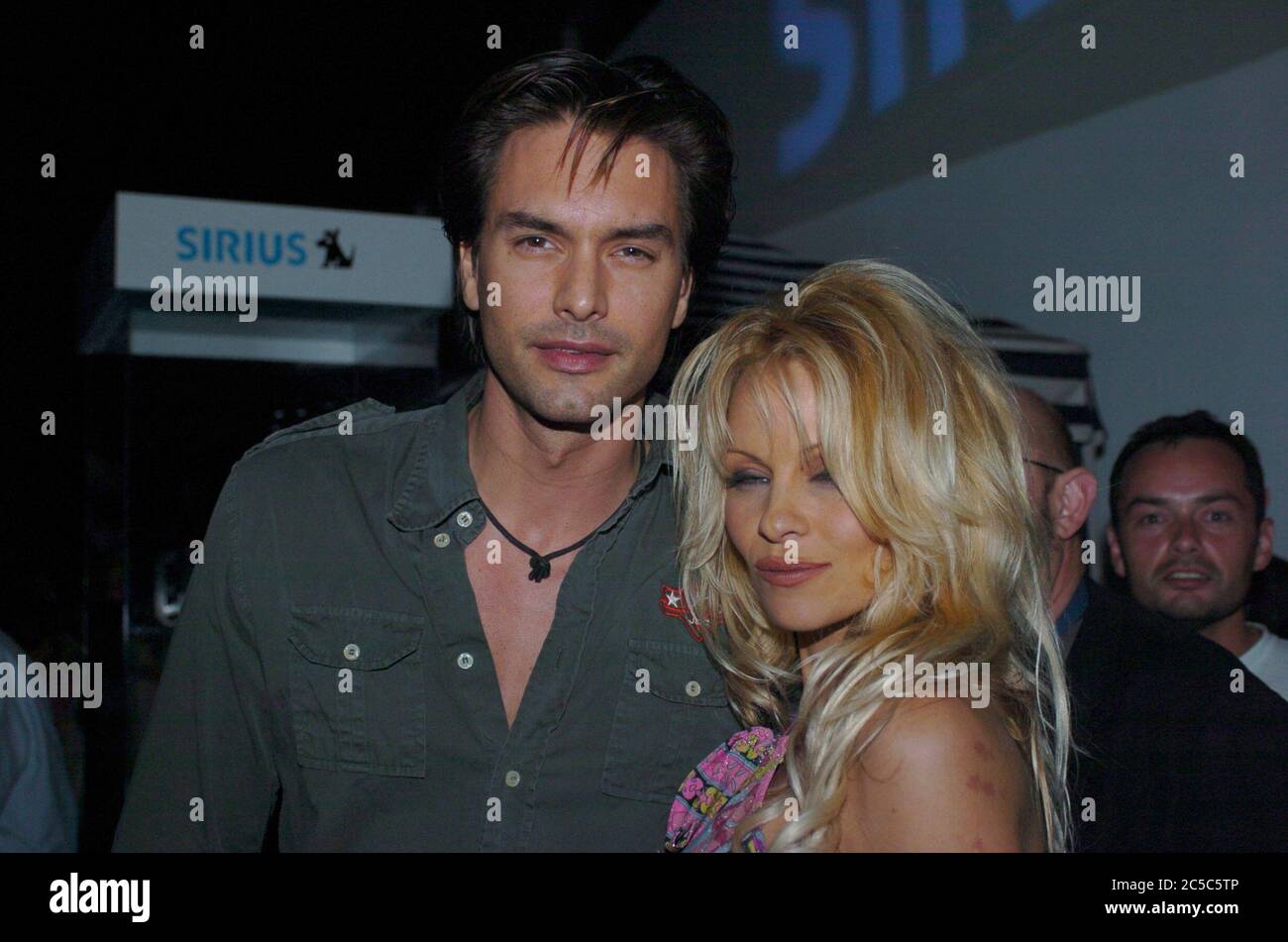 United States Of America. 19th Feb, 2004. MIAMI BEACH, FL - FEBRUARY 19: Pamela Anderson and male super model Marcus Schenkenberg on February 19, 2004 in Miami, Florida People: Pamela Anderson, Marcus Schenkenberg Credit: Storms Media Group/Alamy Live News Stock Photo