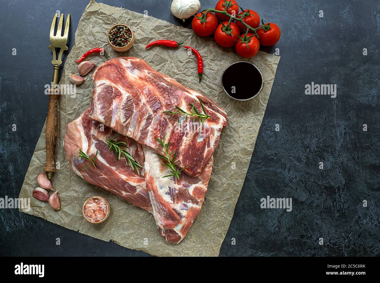 Preparing to cook. Rack of raw pork spare ribs seasoned on a crumpled
