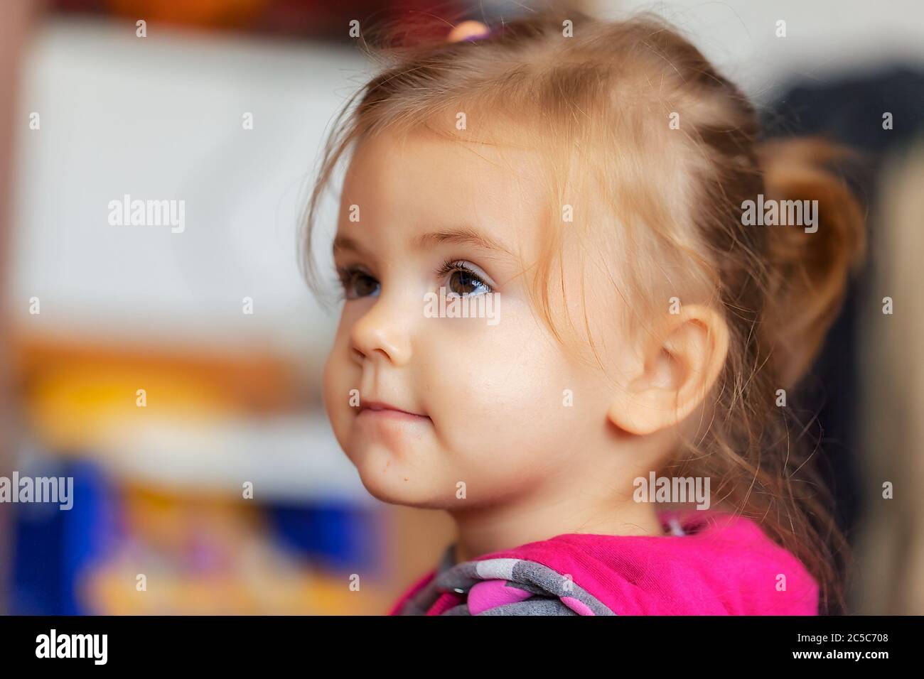 image of a child from profile while watched tv, note shallow depth of field Stock Photo
