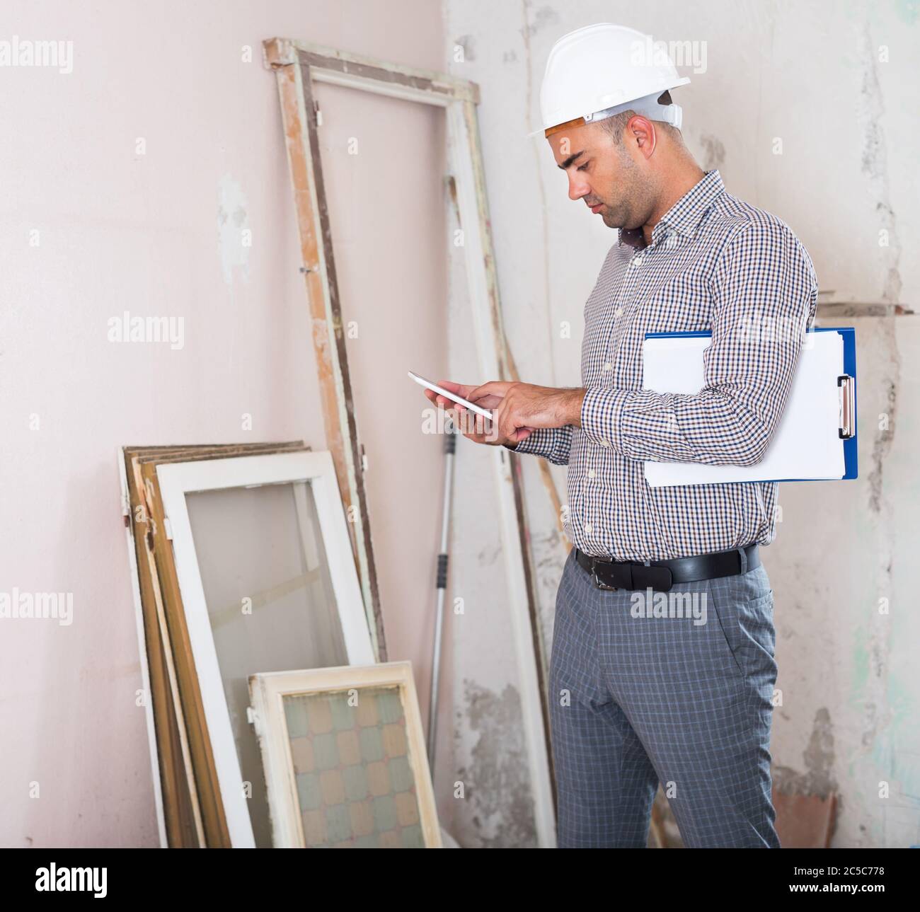 Man engineer with telephone in hand in room Stock Photo