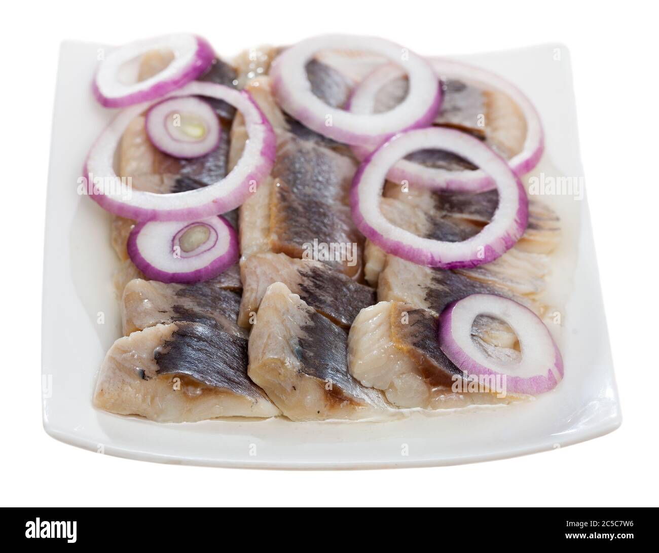 Marinated herring fillet with sliced onion and parsley, healthy food
