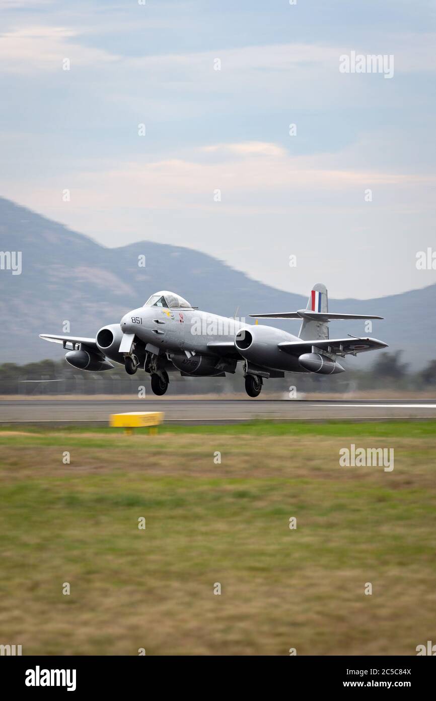 Gloster Meteor F.8 aircraft VH-MBX in Korean War era Royal Australian Air Force (RAAF) markings landing at Avalon airport. Stock Photo