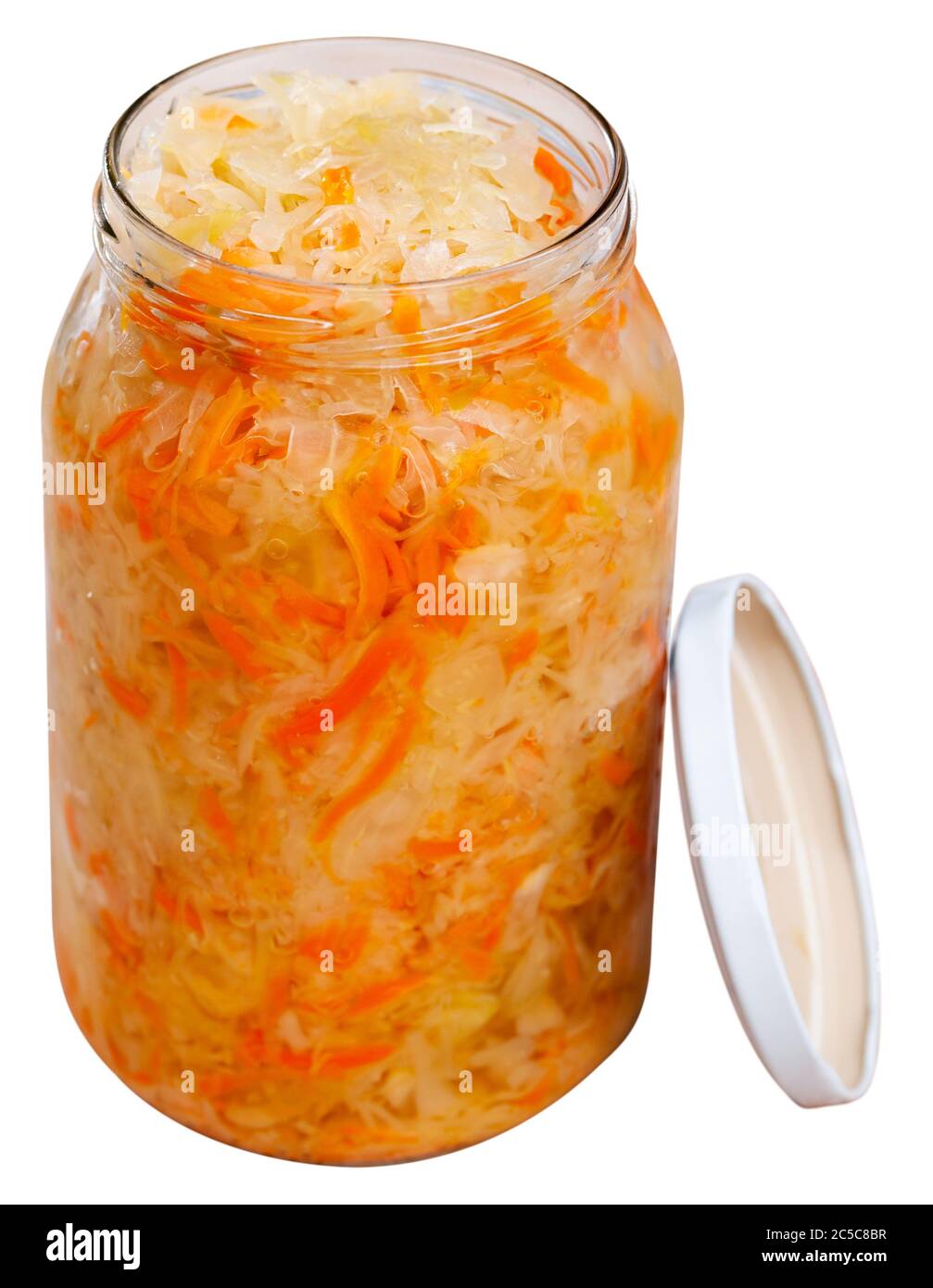 Homemade sauerkraut in glass preserving jar, fermented food. Isolated over white background Stock Photo