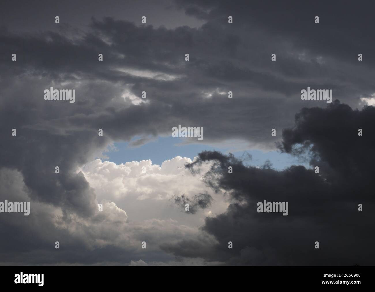 grey stormy sky with clouds and dark city skyline useful as a ...