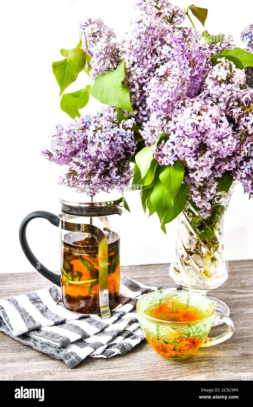 Herbal Tea Cup And Teapot And Violet Lilac Flowers Bouquet In Glass Vase Kitchen Interior Decorations Mother S Day Congratulation Stock Photo Alamy