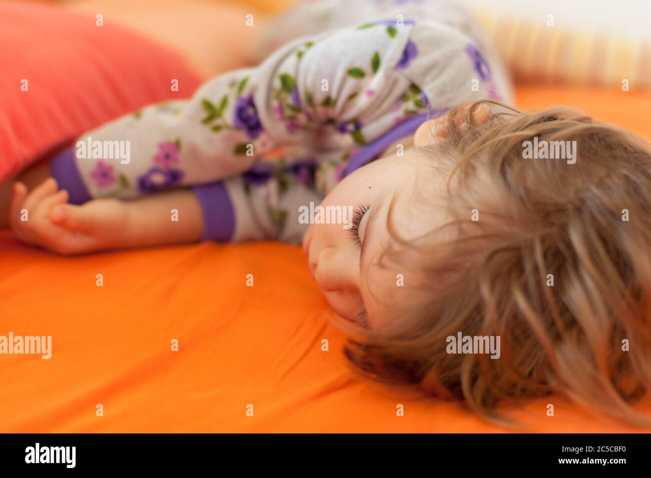 little girl sleeping on the big bed, note shallow depth of field Stock