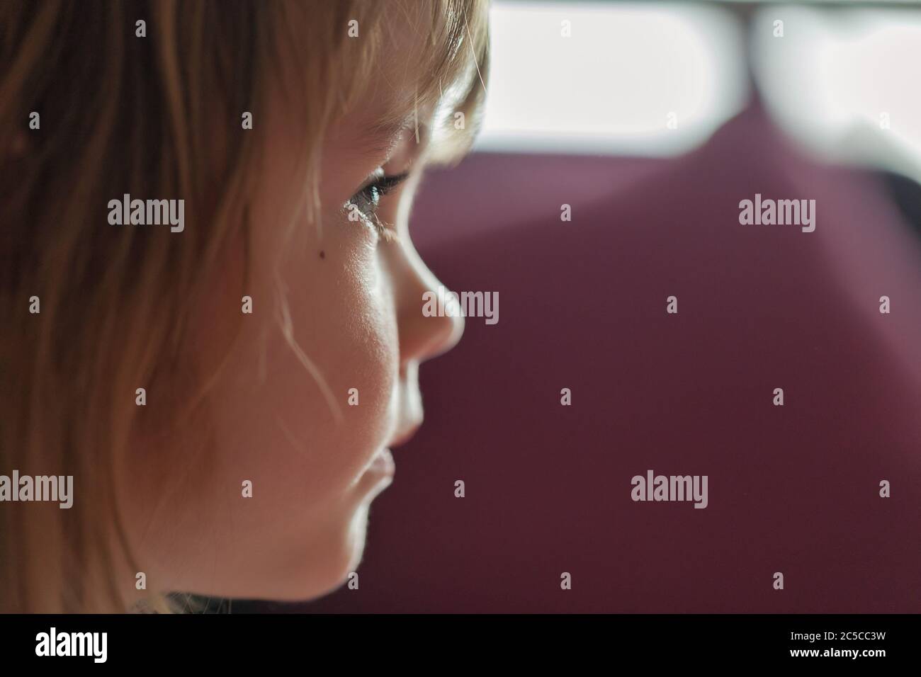 image of a child from profile while looking cartoon, note shallow depth of field Stock Photo