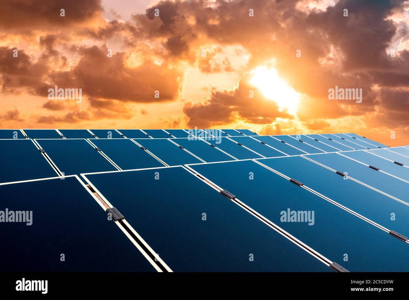 solar energy concept, sunset sky over photovoltaic panels Stock Photo