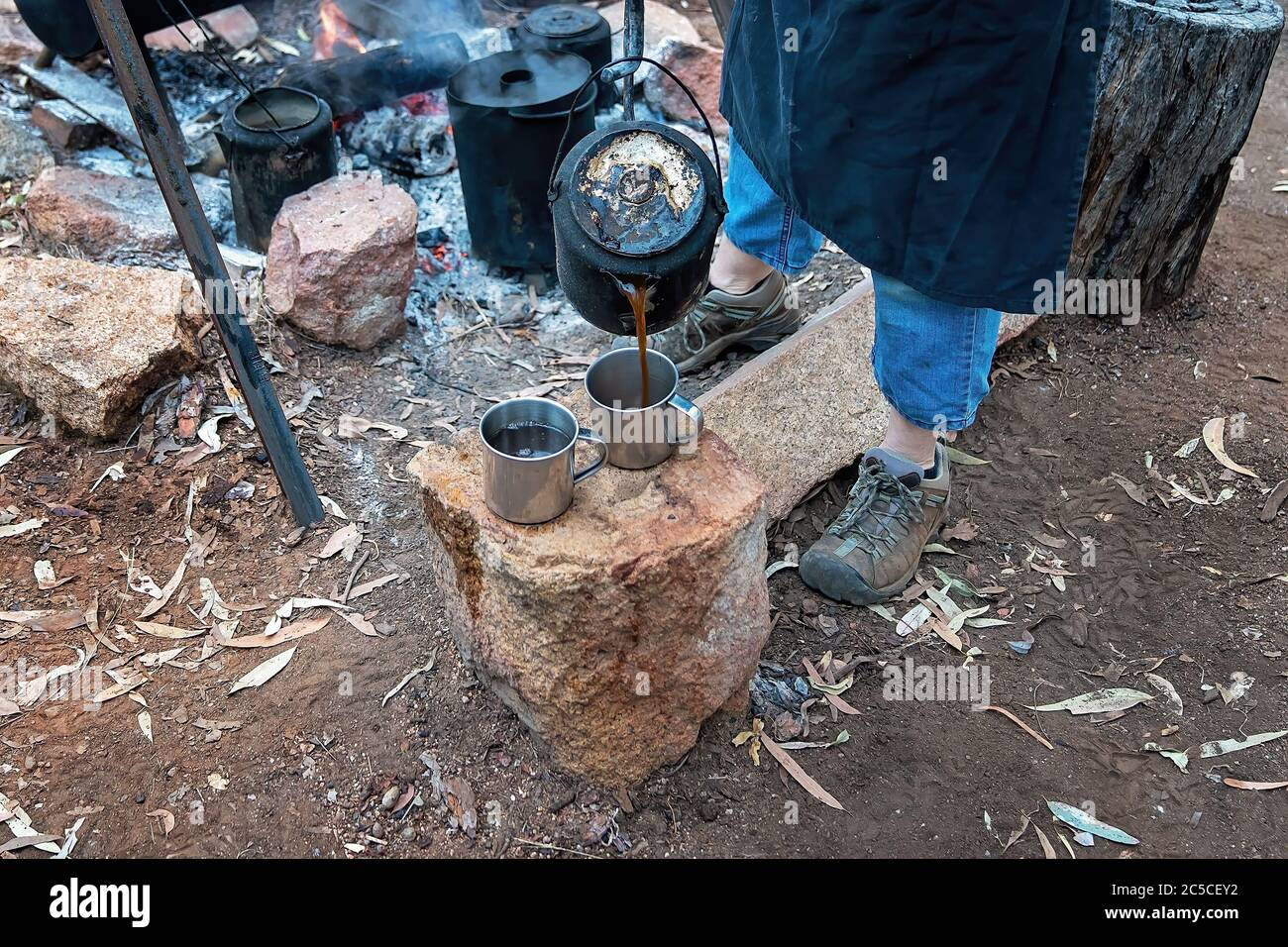 Tea and coffee from a billy at a campfire guest bush breakfast at an outback Australian tourist resort in a volcanic national park Stock Photo