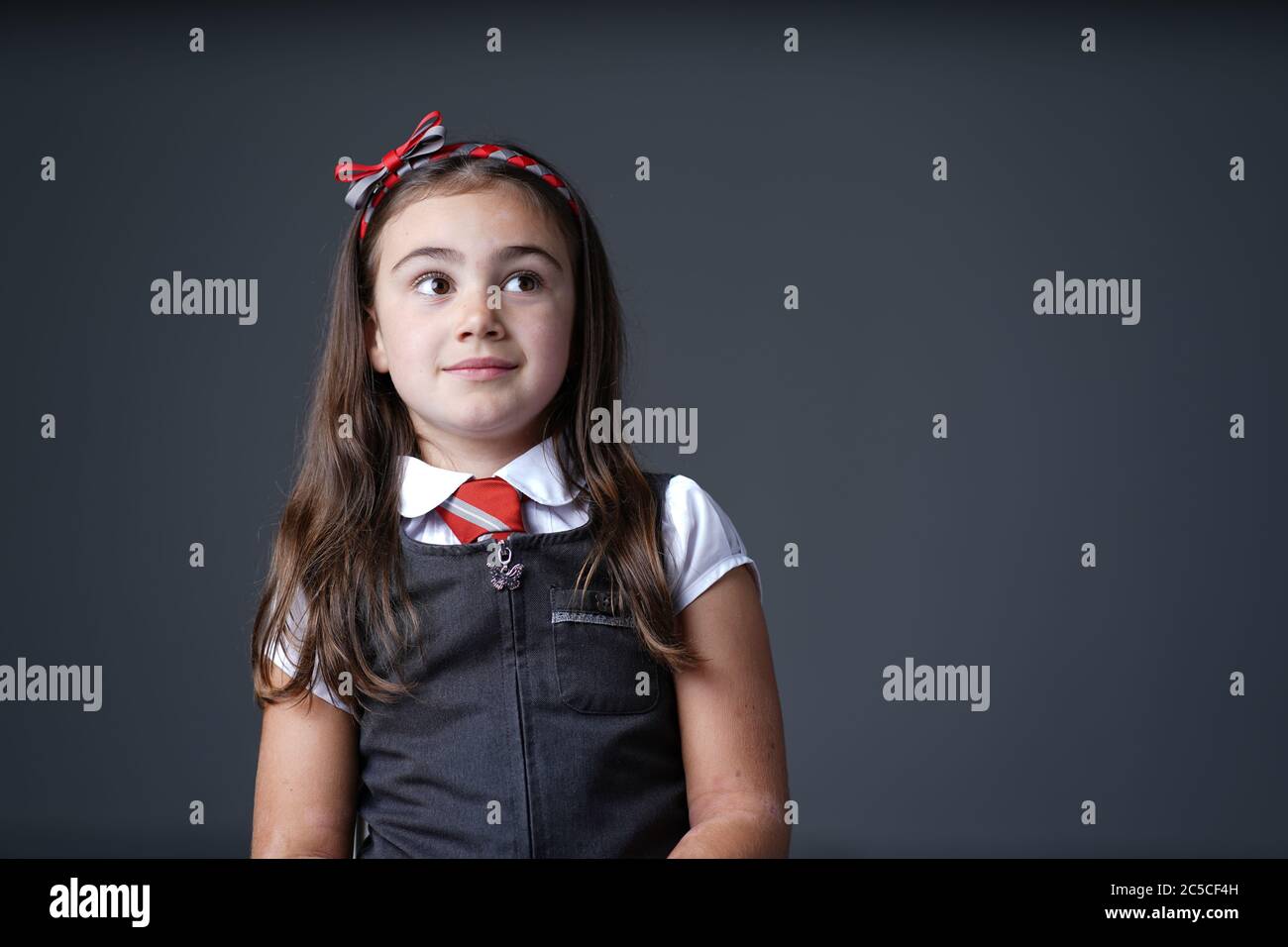 primary school elementary girl child wearing school uniform with grey