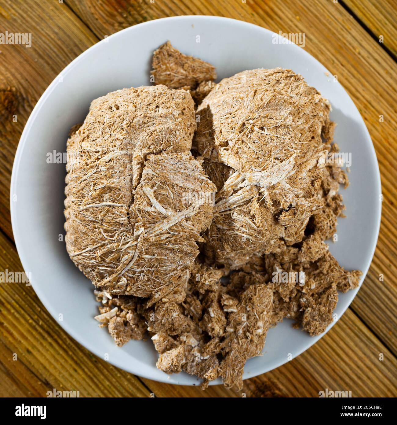 Traditional russian dessert halva from sunflower at plate on table