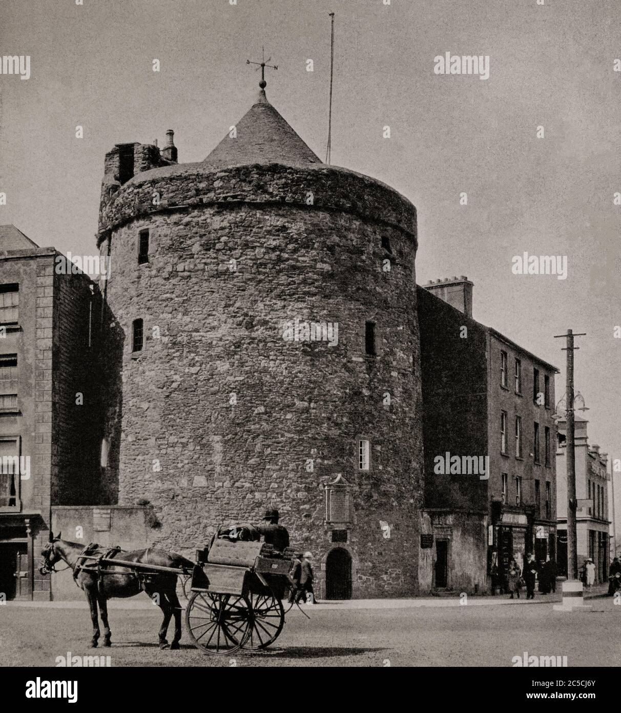 An early 1920's view of a pony and trap riding past Reginald's Tower in Waterford City. Built by the Anglo-Normans to replace an earlier Viking fortification, when Prince John of England landed in Waterford and organised the rebuilding of the city's defences, including the tower between 1253 and 1280. Originally photographed by Clifton Adams (1890-1934) for 'Ireland: The Rock Whence I Was Hewn', a National Geographic Magazine feature from March 1927. Stock Photo