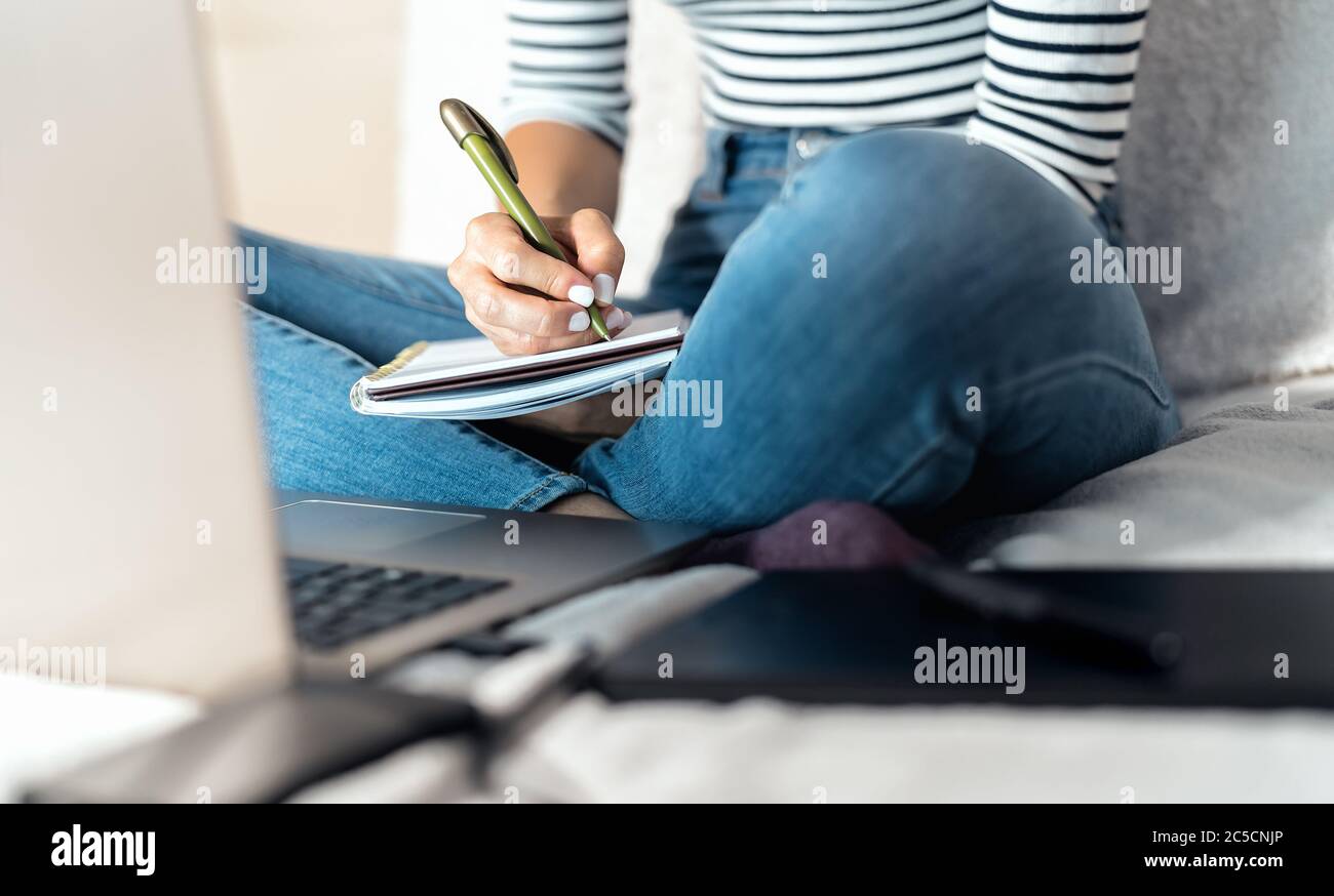 Close up woman smart working on computer at home - Young female studying with laptop in bed - Technology and home worker concept Stock Photo