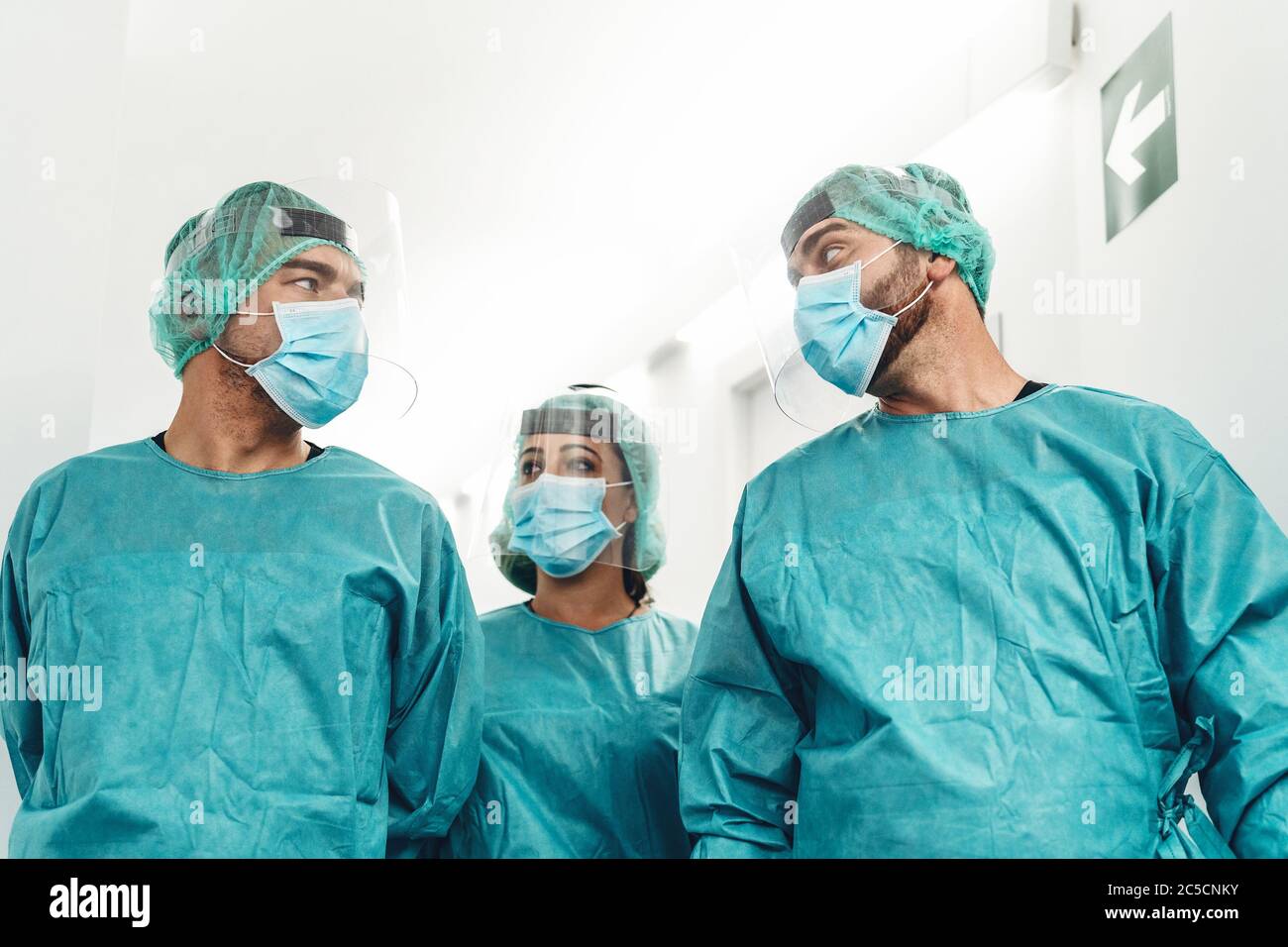 Doctors preparing for surgical operation in hospital during corona virus outbreak - Medical workers getting ready for fighting against coronavirus Stock Photo