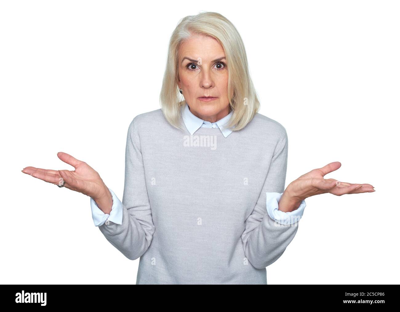 beautiful old woman is shrugging shoulders. Surprised blonde lady Stock Photo