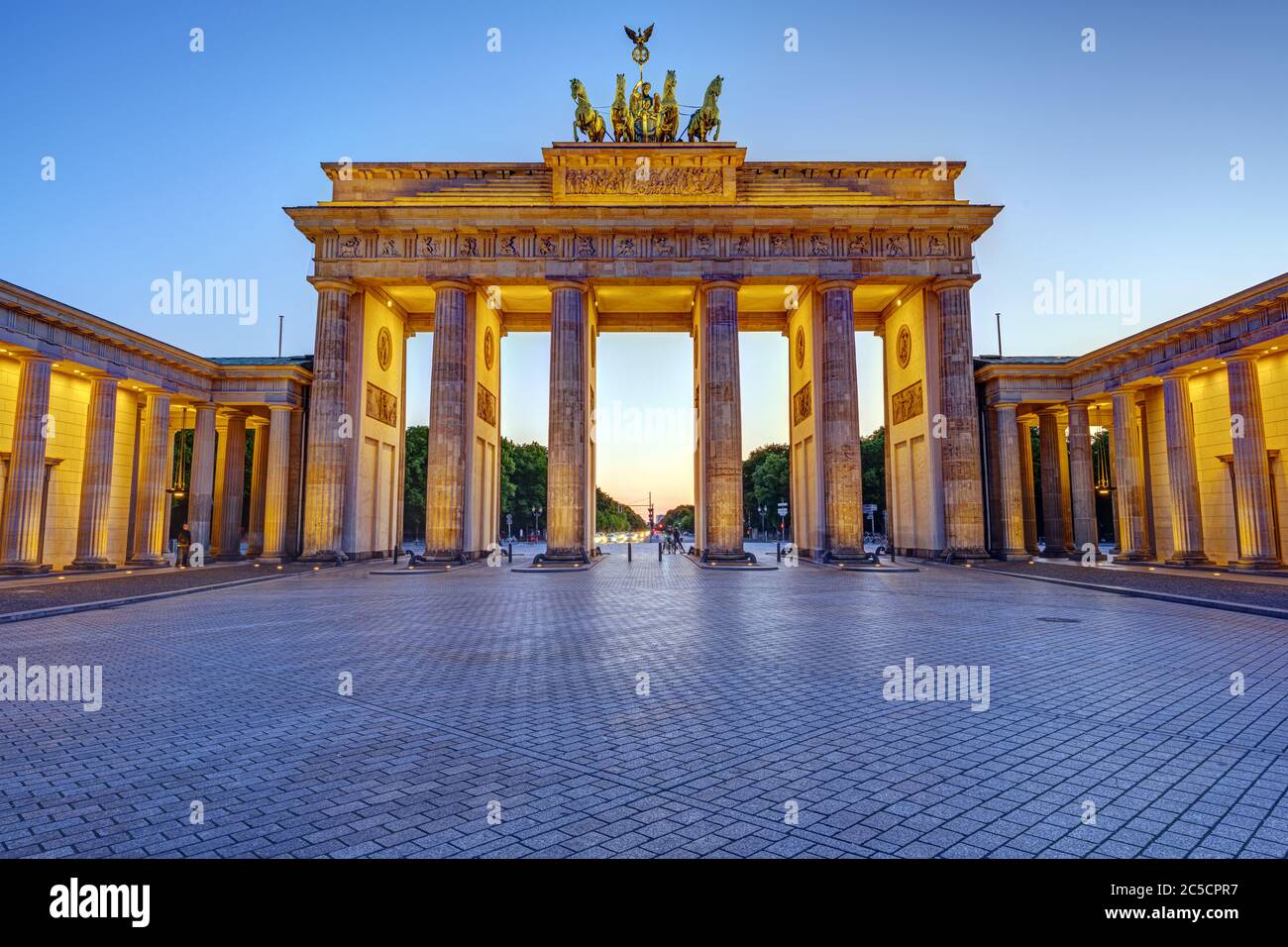 The illuminated Brandenburg Gate in Berlin at twilight with no people Stock Photo