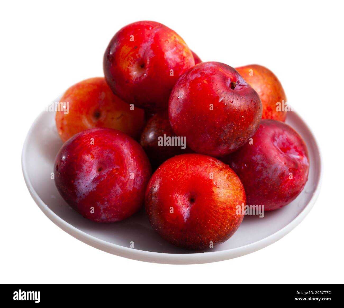 Fresh sweet red plums in plate. Concept of health benefits of fruits