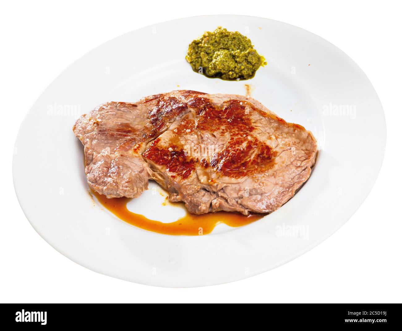 Delicious entrecote with pesto sauce﻿. Isolated over white background