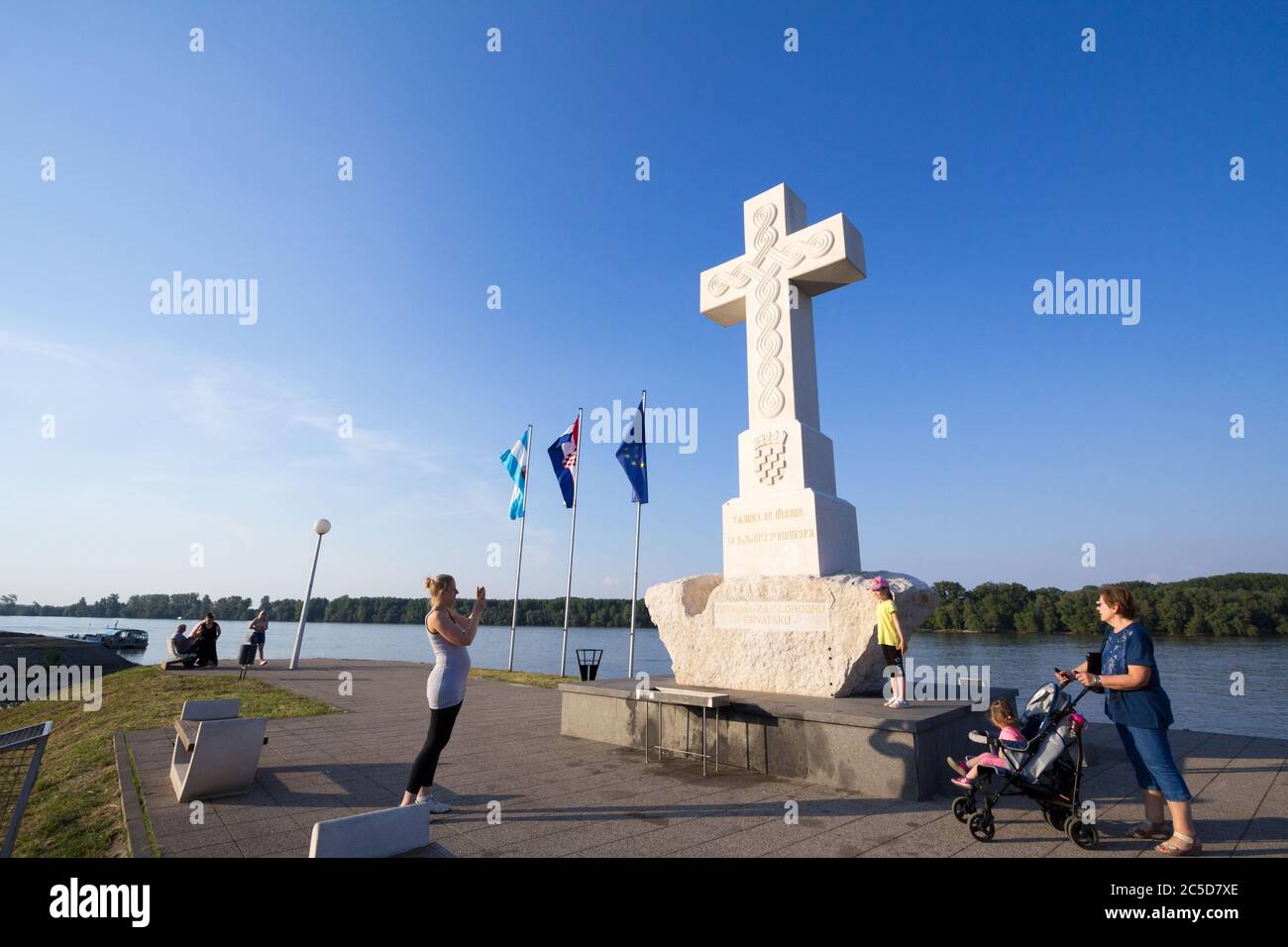 VUKOVAR, CROATIA - MAY 11, 2018: people taking pictures in front of the White Cross, or Bijeli Spomen Kriz, a memorial from the catholic church to peo Stock Photo