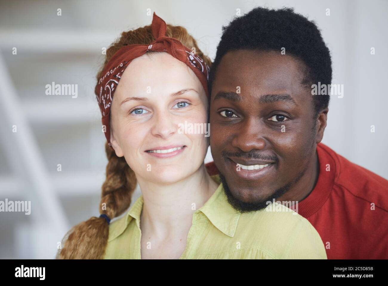 Portrait of multiracial young couple smiling at camera Stock Photo