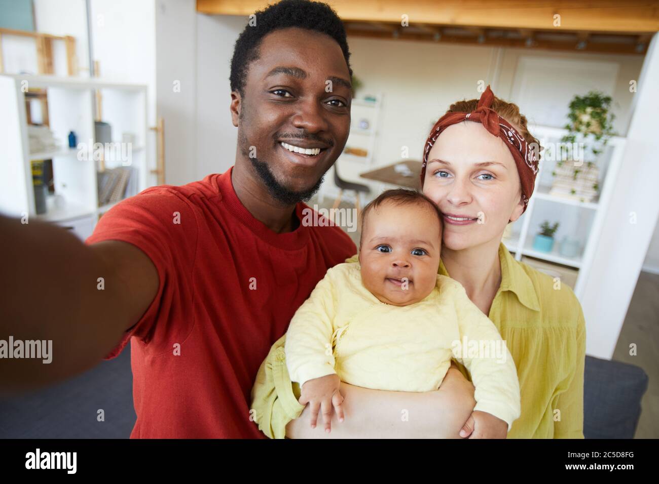 Portrait of happy family with baby girl smiling at camera they making selfie portrait Stock Photo