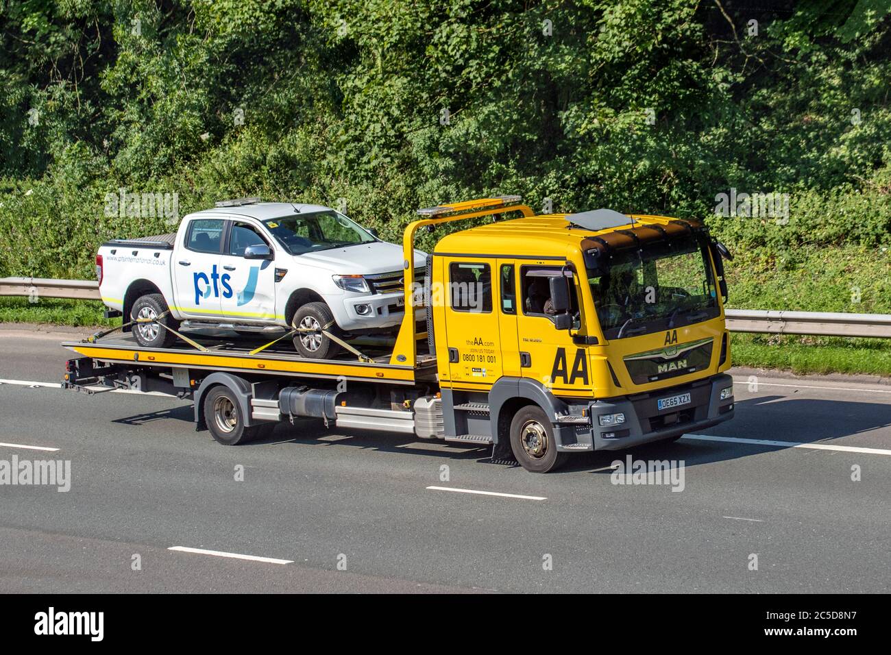 AA 24hr roadside double cab recovery truck; Vehicular traffic moving vehicles, cars driving vehicle on UK roads, 2016 yellow Man TGL motors, motoring on the M6 motorway highway network. Stock Photo