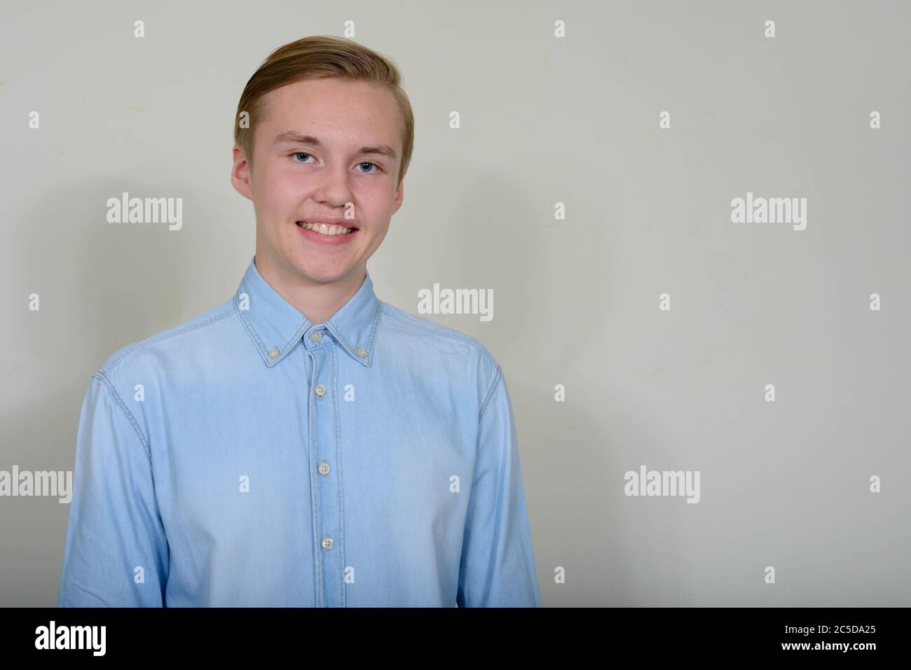 Portrait of happy young handsome blond teenage boy smiling Stock Photo ...