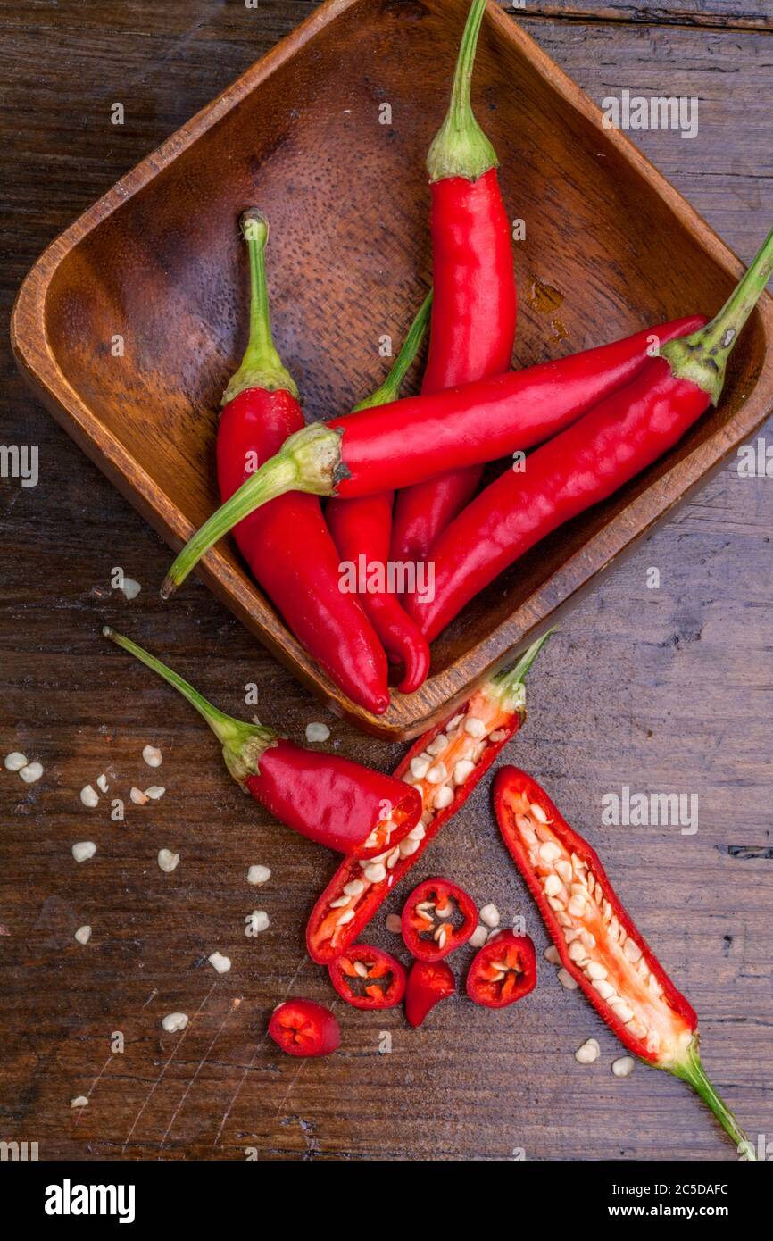 Chili hot peppers in a bowl on wooden table close up. Close up, top view, highresolution