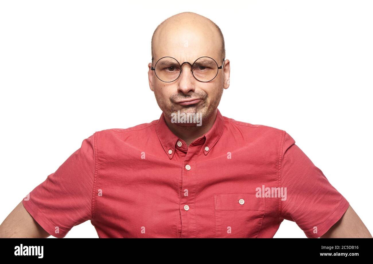 bad-tempered person. Bald man with sceptical expression of his face wearing spectacles. Isolated Stock Photo