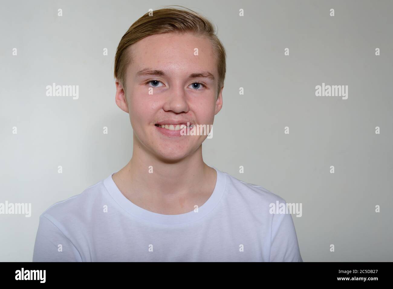 Face of happy young handsome blond teenage boy smiling Stock Photo - Alamy
