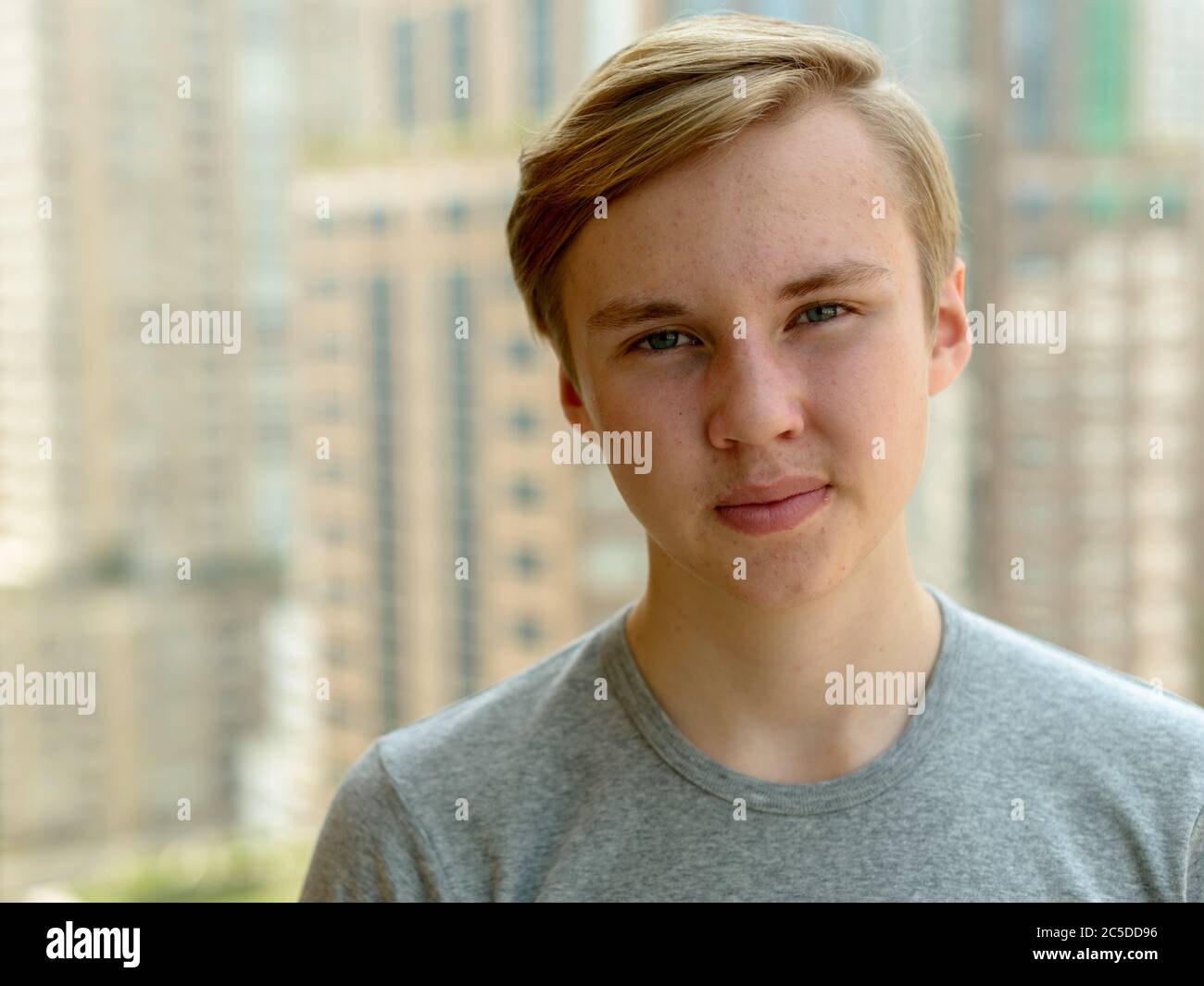 Face of young handsome blond teenage boy against view of the city Stock ...