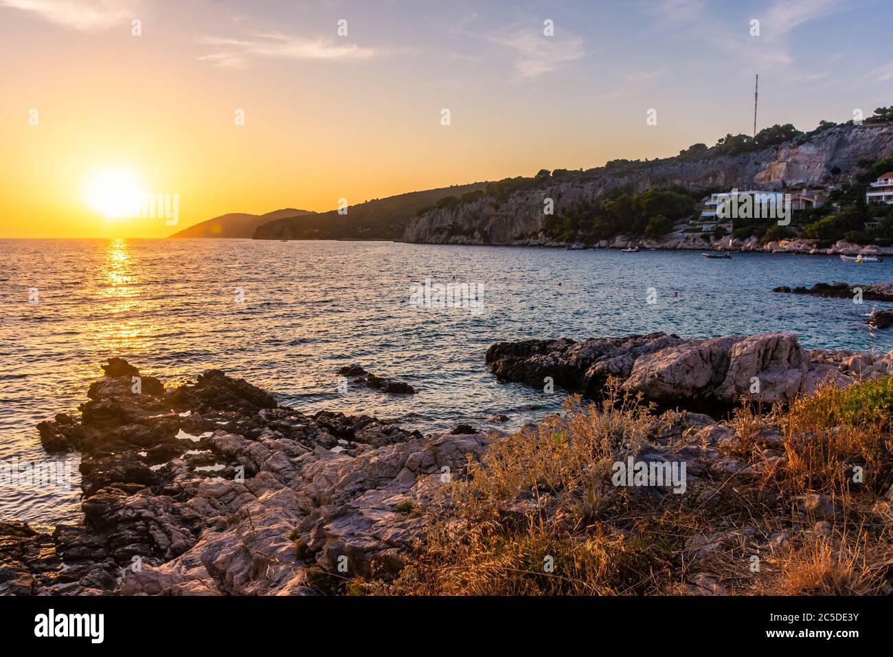 Beautiufl sunset on the rocky beach of Hvar Island, Croatia Stock Photo ...